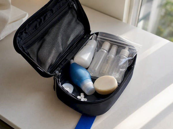 Compact toiletry bag filled with travel-size bottles