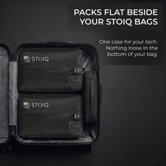 Stoiq Cable Organizer packed flat beside Stoiq compression bags in a carry-on